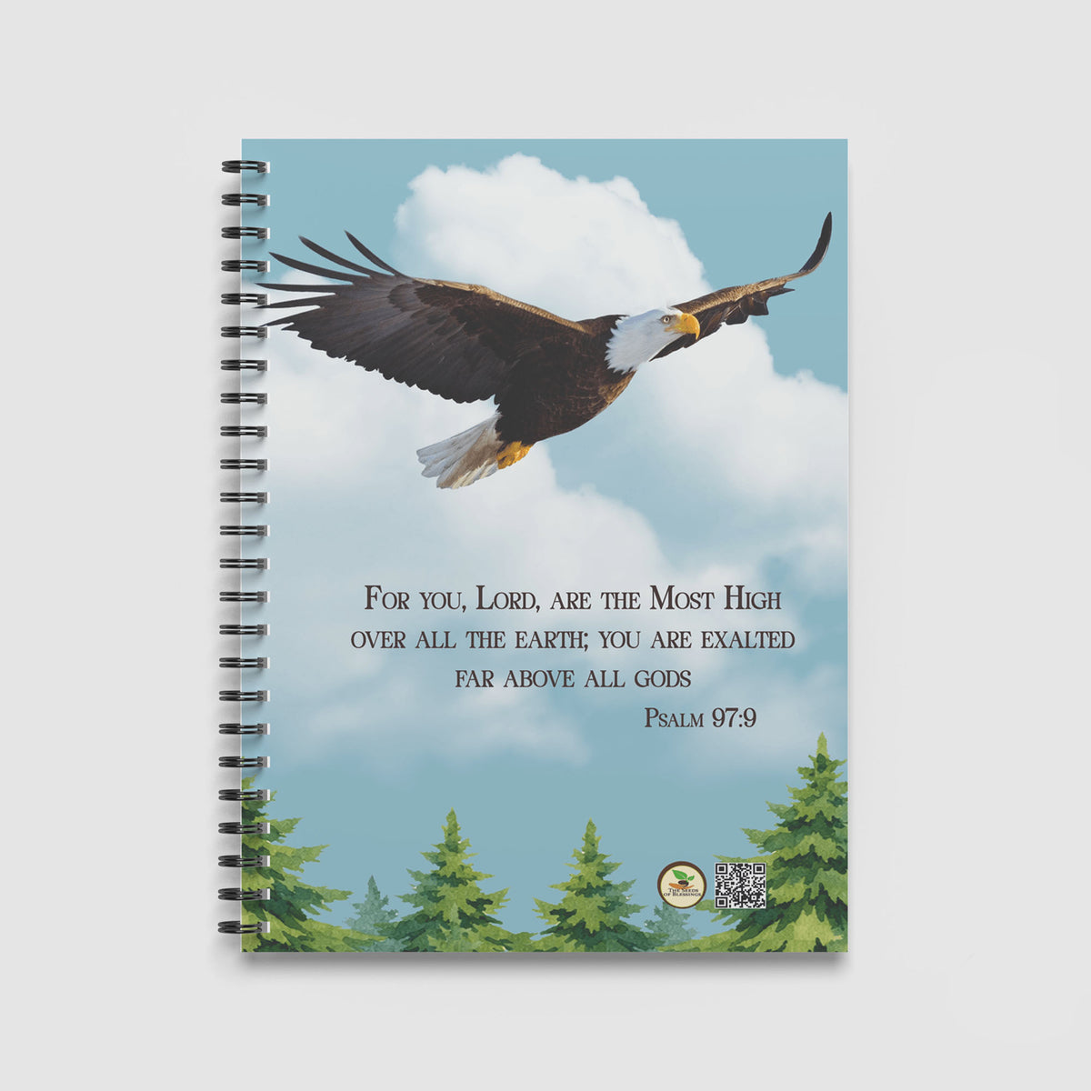 Spiral Notebook A4 - Green pine trees at bottom edge framing the inspirational eagle and scripture design on blue background